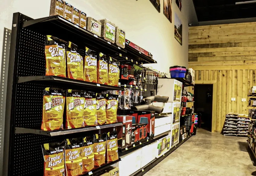 Shelves of Antler King deer attractants and farm supplies in the store