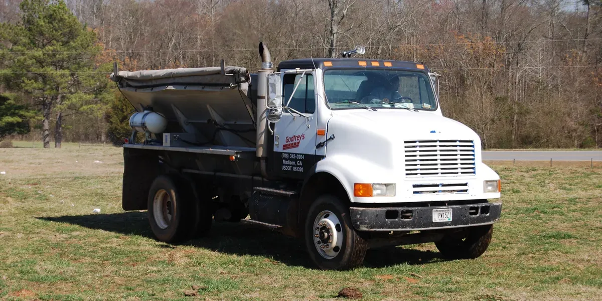 Godfrey's fertilizer spreader truck in a field