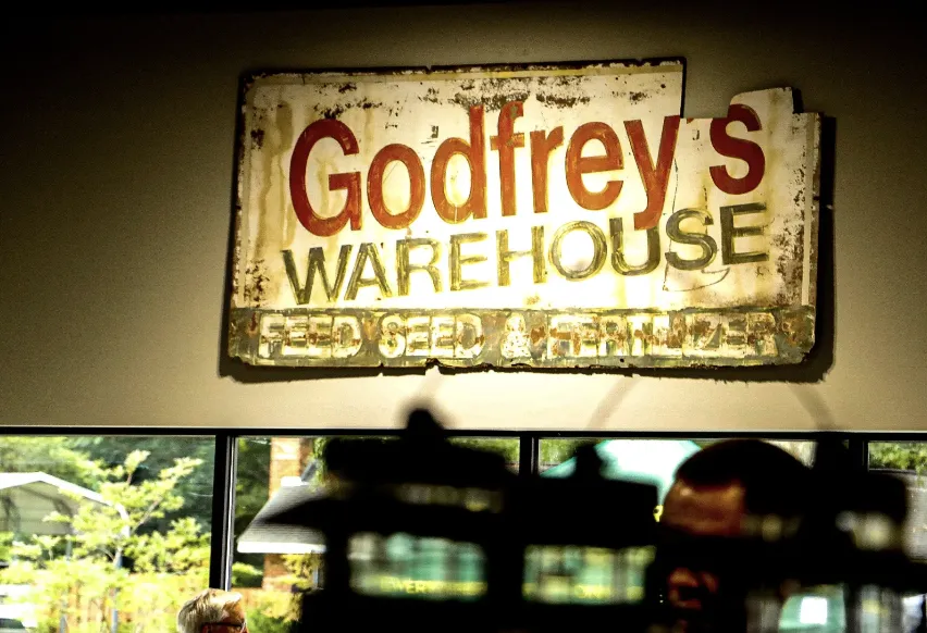 The vintage Godfrey's Warehouse feed, seed and fertilizer sign hanging in the store