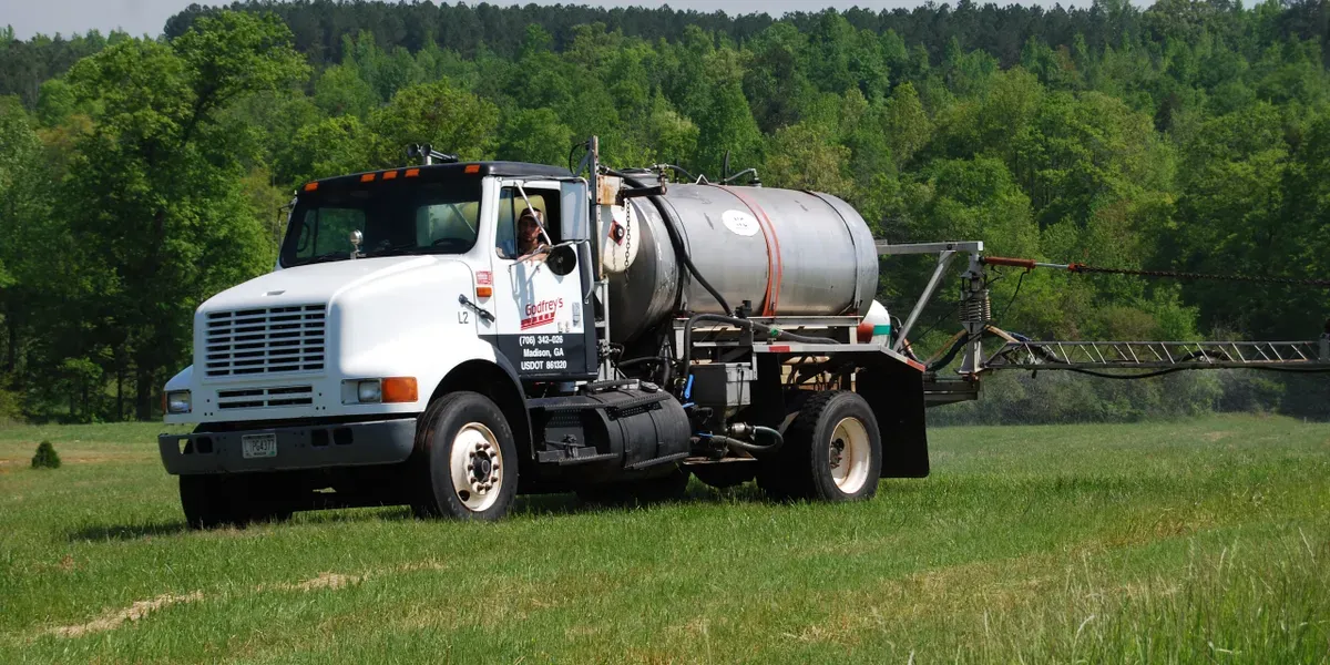 Godfrey's herbicide spray truck working a pasture