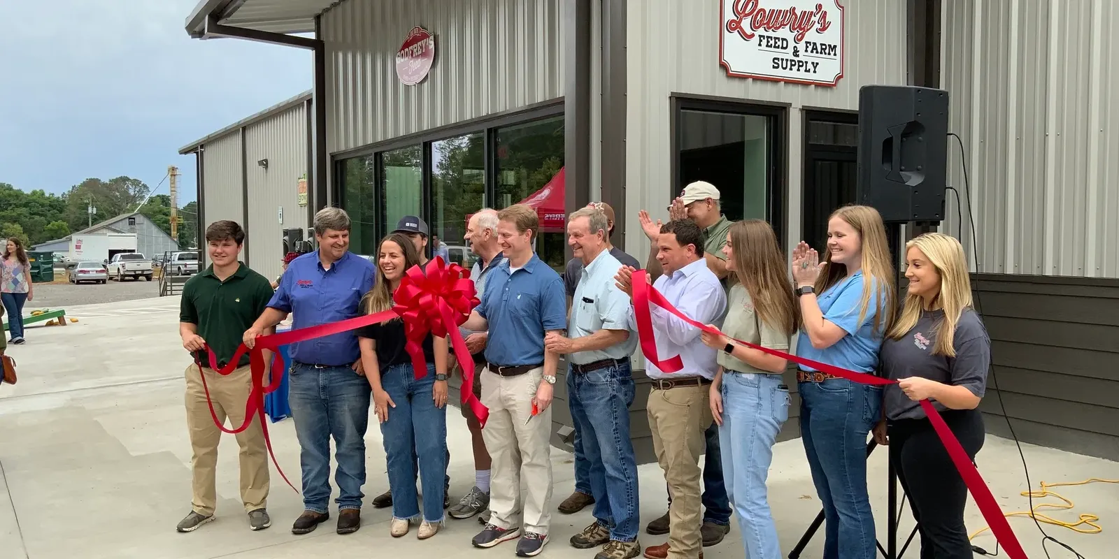 Ribbon cutting in front of the new Lowry's Feed & Farm Supply store in Madison