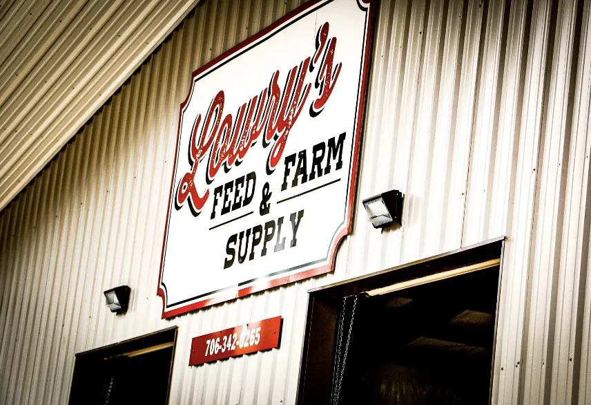 The Lowry's Feed & Farm Supply sign on the metal store building